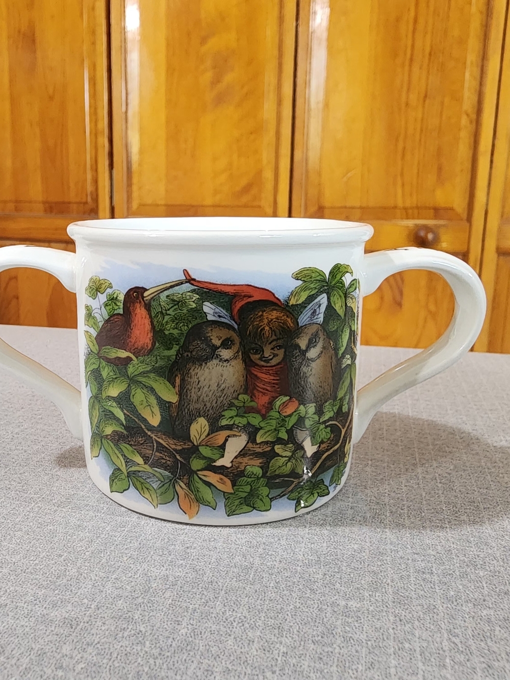 White Two-Handled Ceramic Nursery Rhyme Pot with Bird and Child Illustration